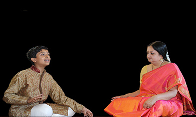 Tara Anand Bangalore (right) and Pratik Bharadwaj on stage, Carnatic singing, 2015; Framingham, Massachusetts;