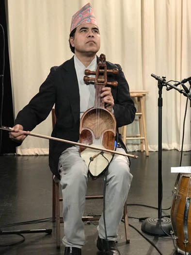 Shyam Nepali playing the sarangi, Nepalese Music, 2018; Watertown, MA; Photography by Maggie Holtzberg