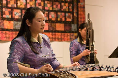 Shin Yi Yang (foreground) playing the guzheng, Chinese guzheng and gu-qin playing, ; Brighton, Massachusetts;