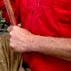 Harold using an adze to shape rudder aperture; Apprenticeship - wooden boat building; 2006: Essex, Massachusetts