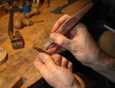 Close up of chiseling out mortise; bow maker; 2011; David Hawthorne; Cambridge, Massachusetts; wood, ivory, metal thread