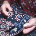 Anahid Kazazian holding Marash embroidery done by her grandmother, circa 1866; Armenian embroidery; 2002: Lexington, Massachusetts