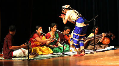 Dance performance of apprentice, Amudha Pazhanisamy. Master artist Ranjani Saigal second from left of seated musicians.; Apprenticeship - Bharatanatyam dance; 2008: Lexington, Massachusetts